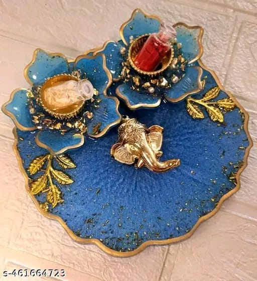 Blue floral pooja thali with a central Ganesha face